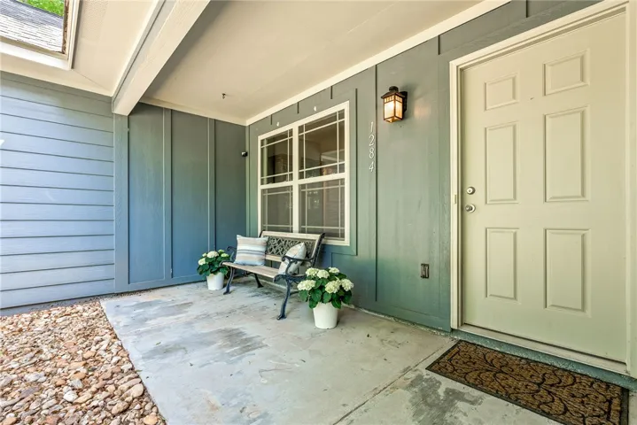 This charming entrance features a welcoming porch, perfect for greeting guests.