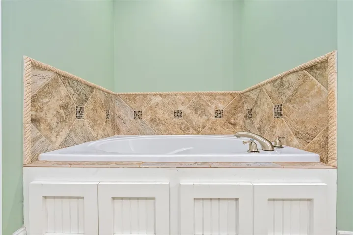 Relax and unwind in this inviting bathroom featuring a tiled soaking tub.