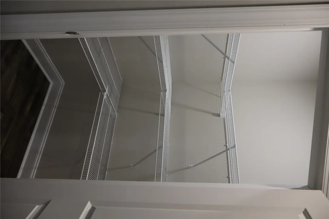 This spacious pantry provides ample storage with built-in wire shelving, perfect for organization.