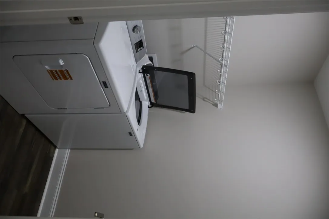 This dedicated laundry space features practical storage and efficient appliances for everyday convenience.