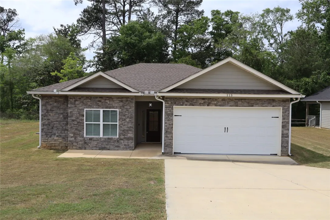 This charming home offers modern comfort with a classic stone facade.