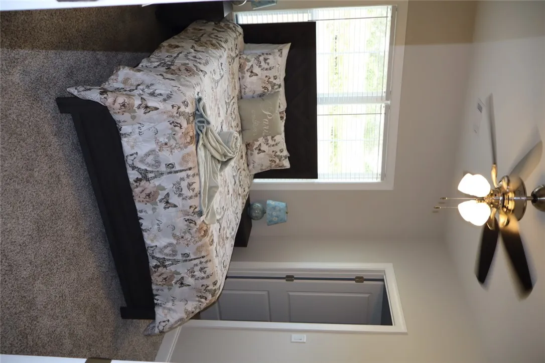 This cozy bedroom features comfortable flooring, ideal for a peaceful retreat.