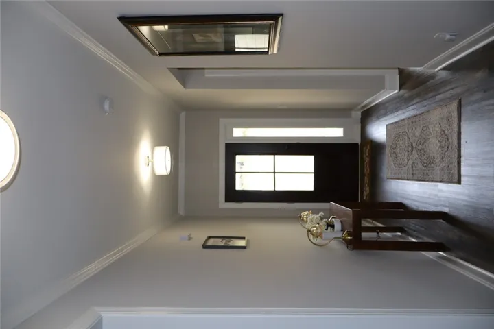 Enter into this inviting space, where elegant flooring and ample lighting create a welcoming atmosphere.