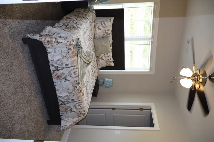 This cozy bedroom features comfortable flooring, ideal for a peaceful retreat.