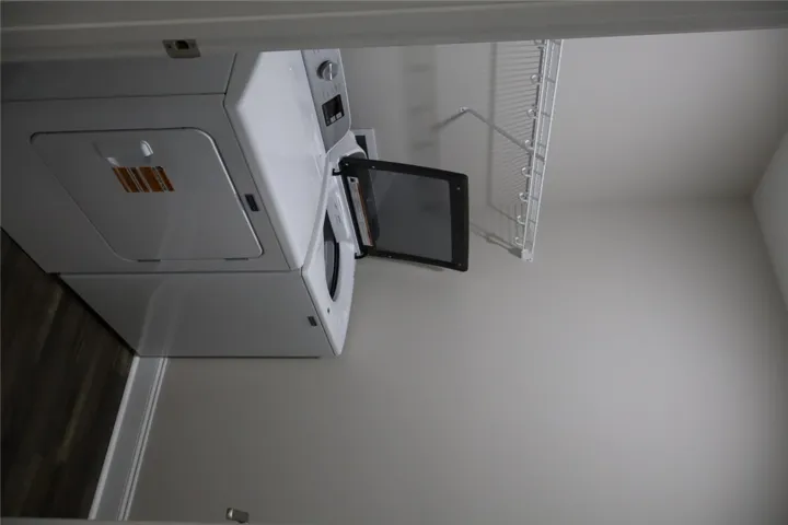 This dedicated laundry space features practical storage and efficient appliances for everyday convenience.