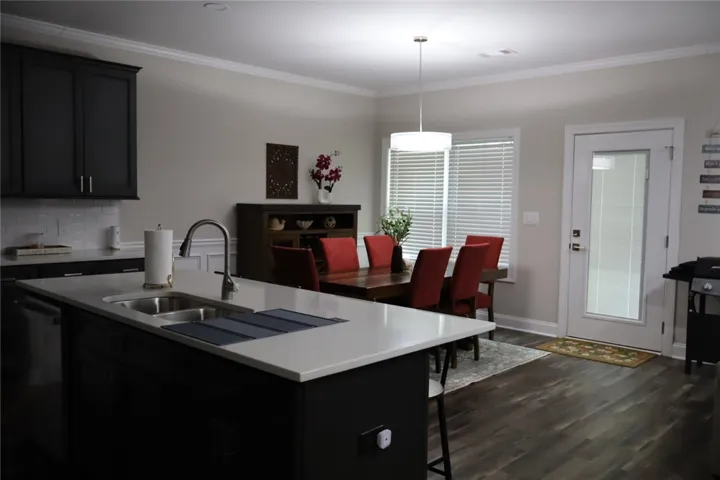 This kitchen and dining area features a large island and ample natural light.