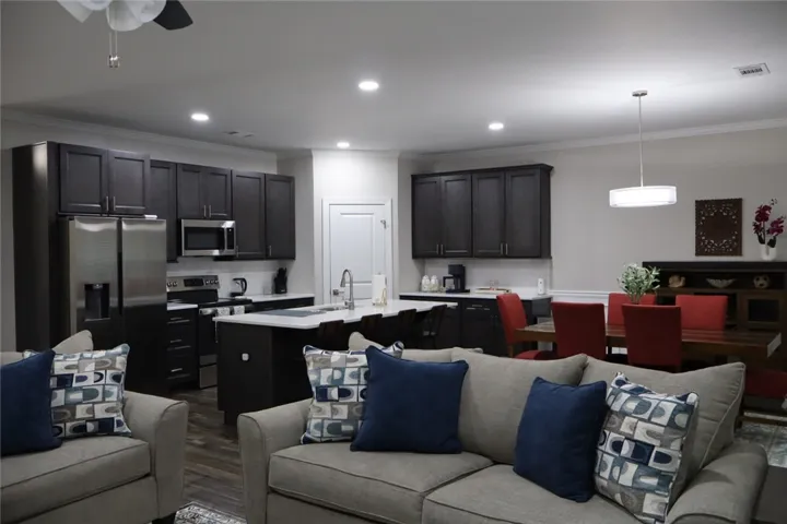 This open concept living space features a modern kitchen and dining area.
