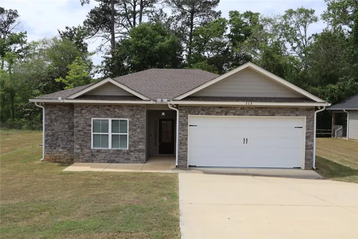 This charming home offers modern comfort with a classic stone facade.