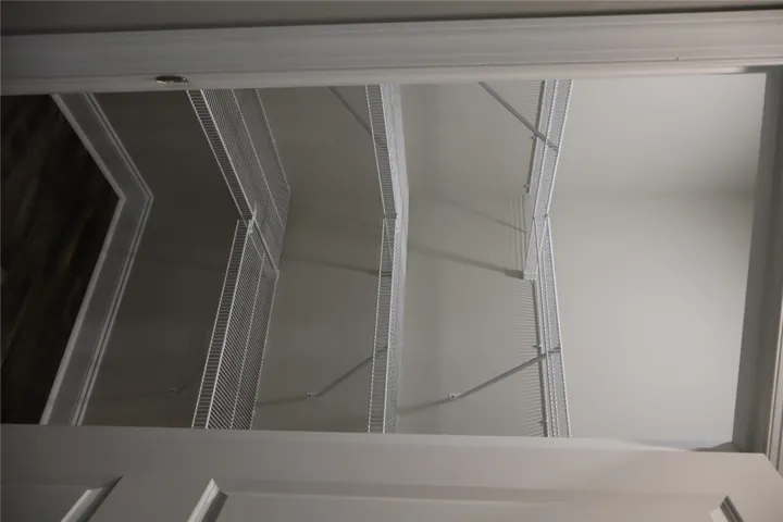 This spacious pantry provides ample storage with built-in wire shelving, perfect for organization.