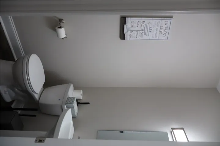 This clean and functional powder room offers essential amenities for comfort.