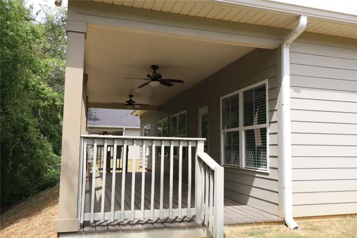 This inviting covered porch provides a seamless transition to the outdoors, perfect for tranquil moments.