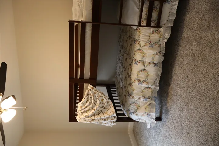 This cozy bedroom features comfortable bunk beds and soft carpeting.