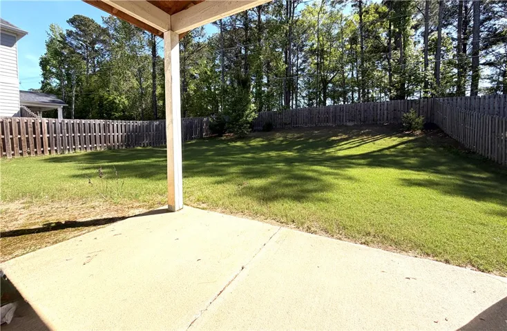 This spacious private yard offers a tranquil retreat for outdoor living and entertaining.