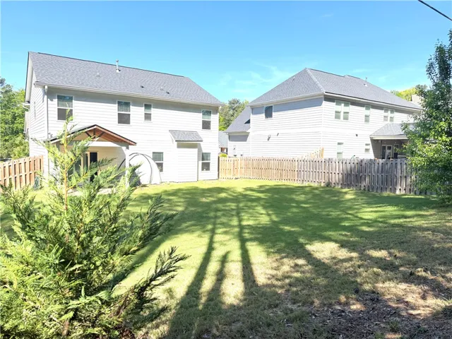 This spacious backyard offers privacy and room for outdoor enjoyment.