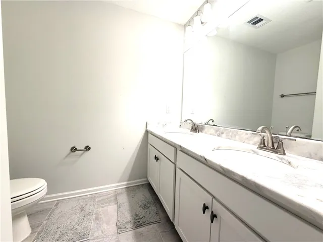 This bathroom features a double vanity with ample counter space and sleek fixtures.