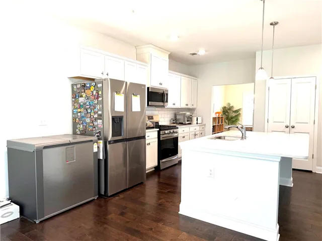 This bright kitchen features sleek appliances and a spacious island, perfect for culinary endeavors.