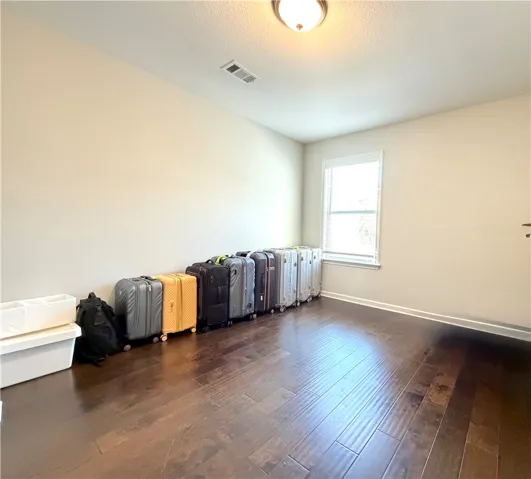 This versatile room features warm hardwood floors and abundant natural light.