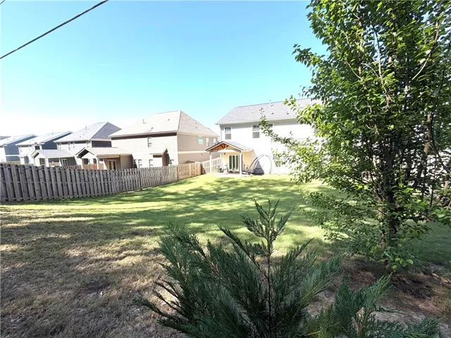 This spacious yard offers ample green space for outdoor enjoyment and recreation.