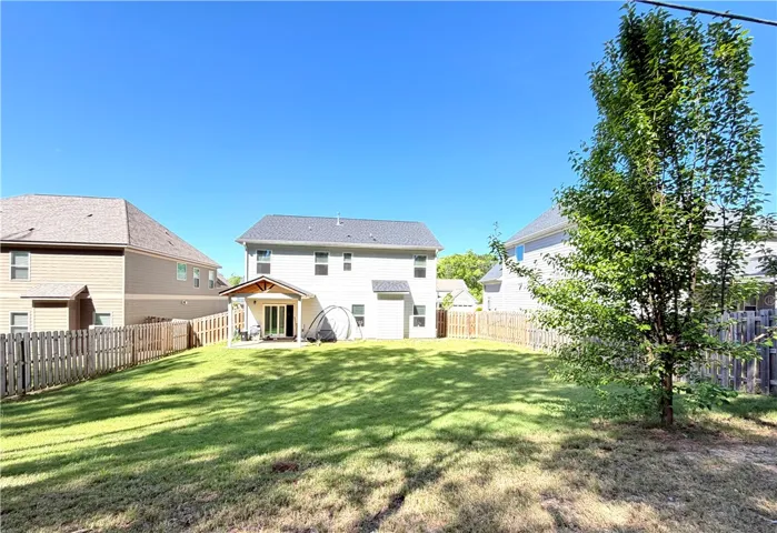 This spacious backyard offers privacy and room for outdoor activities.
