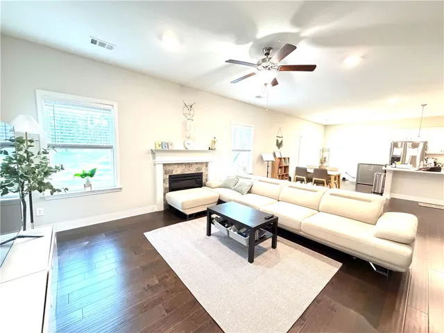 This inviting space features an open layout and a cozy fireplace, perfect for daily living and entertaining.