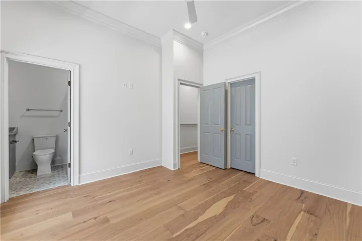 Bright room with pristine hardwood floors and convenient closet space.