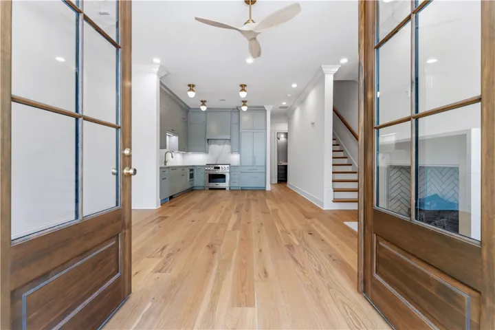 Step into a luminous space featuring an open layout, hardwood floors, and a well-appointed kitchen.