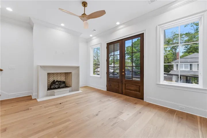 This bright living space features elegant hardwood floors and a cozy fireplace.