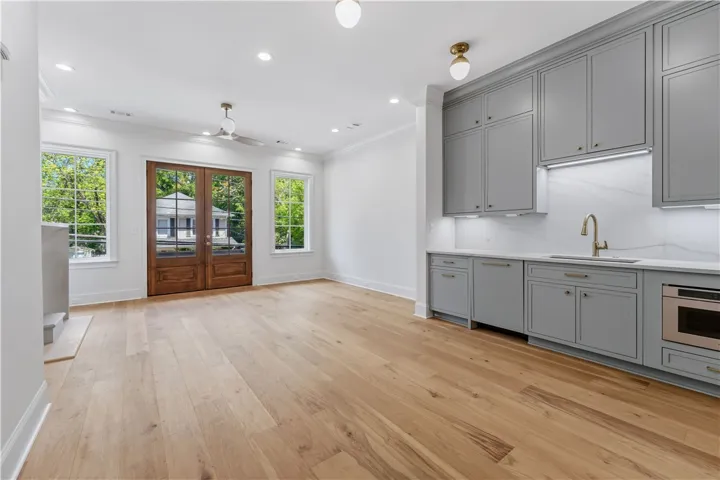 Bright, airy space features a beverage station, warm wood floors, and abundant natural light.