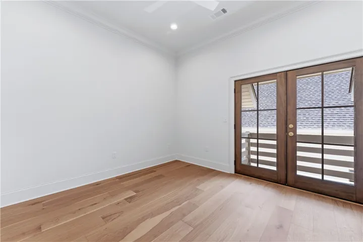 This bright room features beautiful hardwood floors and a balcony for outdoor access.