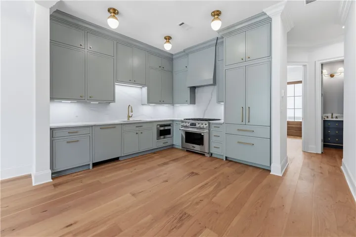 This newly renovated kitchen features a pristine culinary space with sleek cabinetry and modern amenities.