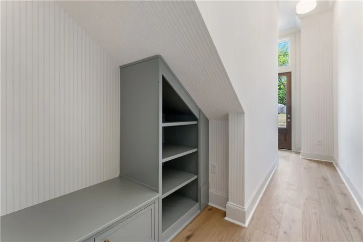 This inviting entry features custom built-ins and rich hardwood floors, creating a functional and stylish welcome.