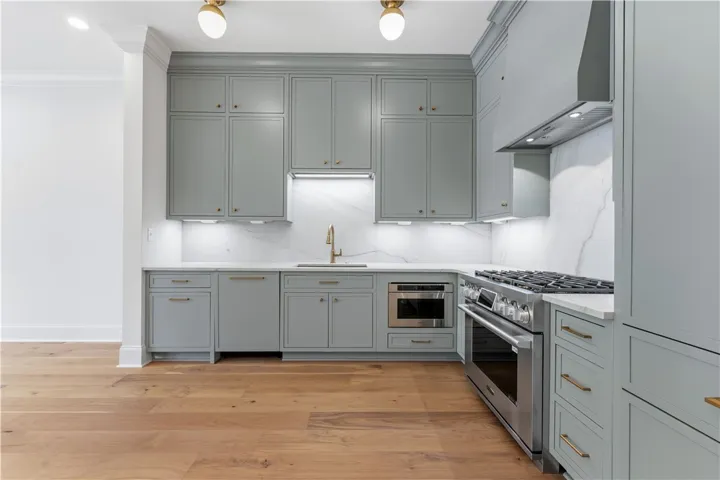 This sleek kitchen features hardwood floors and state-of-the-art appliances, perfect for culinary endeavors.