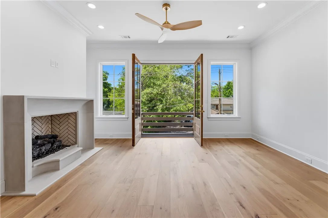 This airy room features a fireplace and a balcony, perfect for relaxation or entertaining.