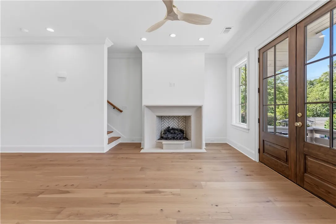 This bright living space features hardwood floors and a cozy fireplace, perfect for gatherings.