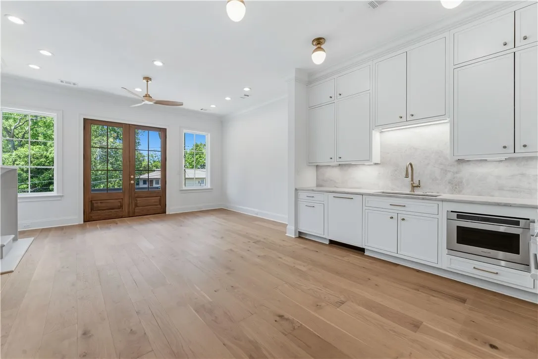This bright space features sleek cabinetry, a convenient wet bar, and abundant natural light.