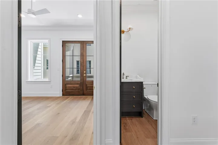 This interior offers beautiful hardwood flooring, French doors, and a well-appointed bathroom.