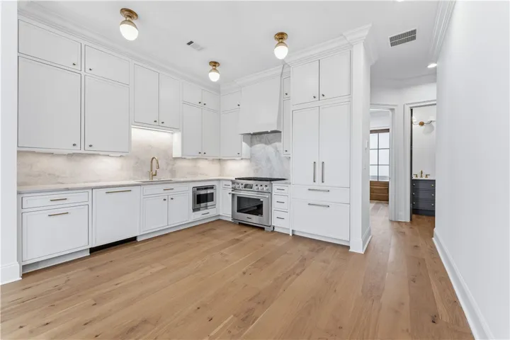 This bright kitchen features ample cabinetry and integrated appliances for modern living.