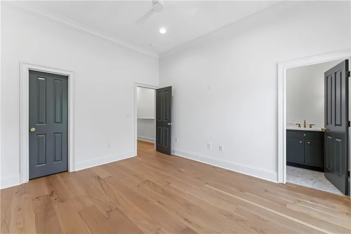 This spacious room features elegant hardwood flooring and convenient access to an adjacent bathroom.