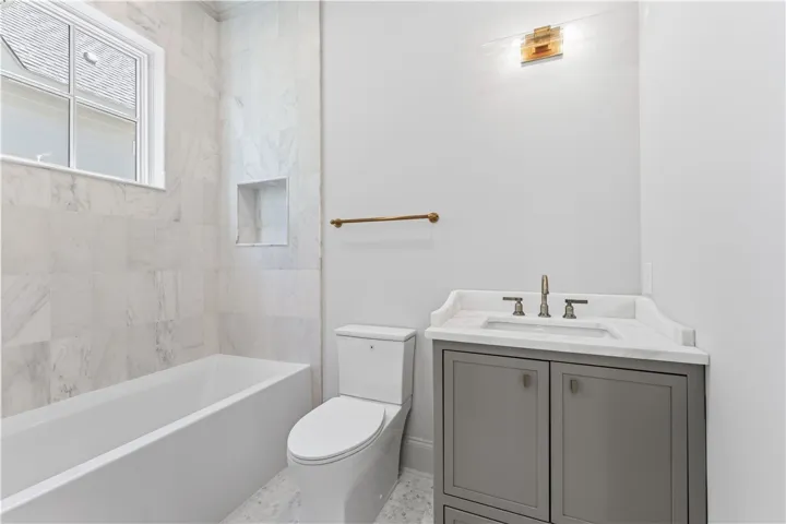 This sleek bathroom features elegant fixtures, creating a serene and functional space for daily routines.