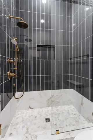 This sleek shower features modern fixtures and exquisite tiling.