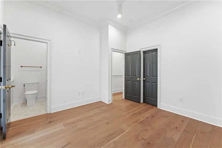 This bright space features rich hardwood flooring and crown molding, enhancing its architectural appeal.