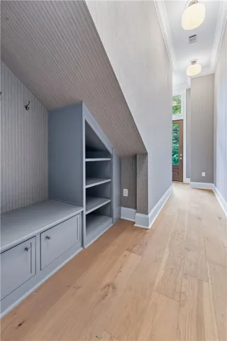 This entry offers functional built-in storage, maximizing space with elegant design.