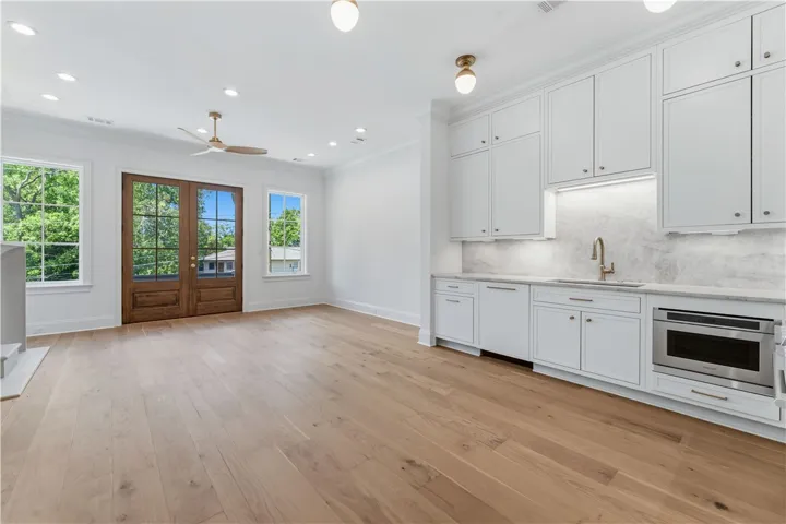 This bright space features sleek cabinetry, a convenient wet bar, and abundant natural light.
