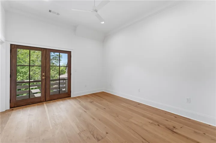 This spacious room offers hardwood flooring and ample natural light, creating an inviting atmosphere.