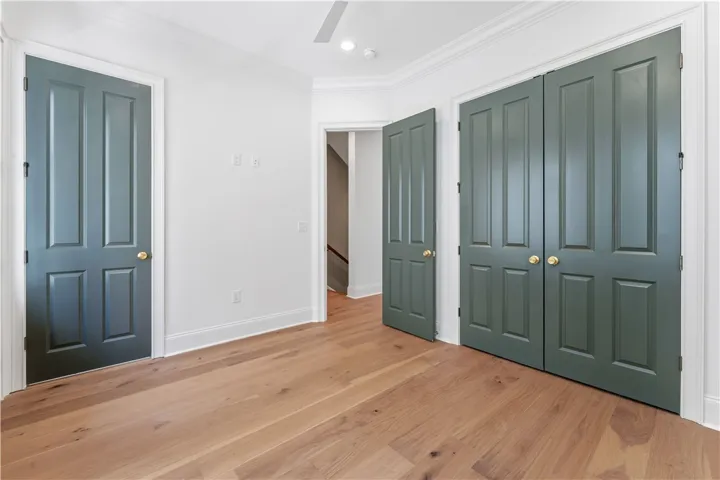 Bright room with smooth hardwood floors and classic panel doors.