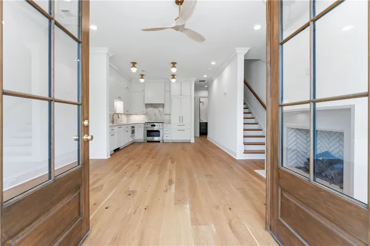 This bright, open concept living space seamlessly integrates kitchen and living areas, offering a perfect blend of comfort and style.