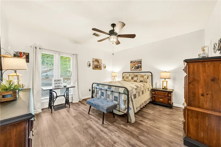 This spacious bedroom offers ample natural light and a serene ambiance.