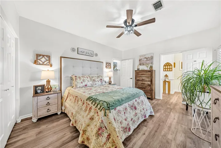 This inviting bedroom features rich hardwood flooring, creating a comfortable and elegant personal retreat.