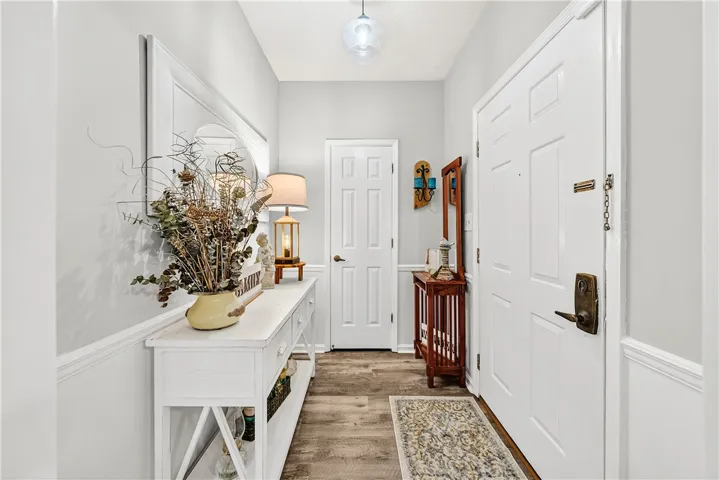 This inviting entryway features warm flooring, crisp white trim, and ample space.