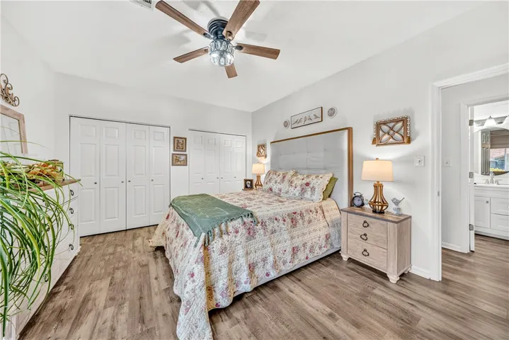 This spacious bedroom features ample closet space and durable flooring for comfortable living.